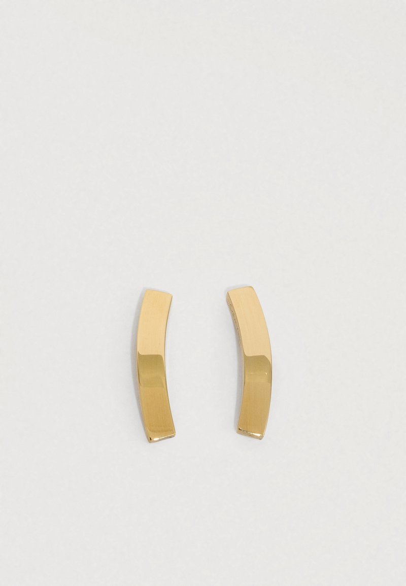 Gullfargede metalløredobber med en buet, avlang design. Overflaten er glatt og polert, med en minimalistisk stil.