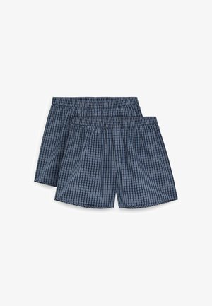 Deux paires de caleçons pour hommes en coton à carreaux bleu et noir avec ceintures élastiques sur fond blanc.