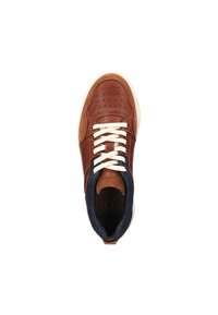 Brown leather sneaker with white laces, perforated design, navy accents, and a textured upper. Features a rounded toe and cushioned collar.