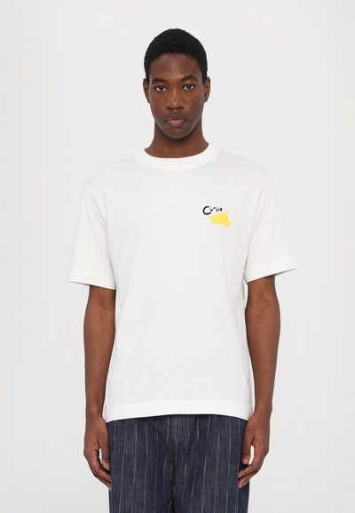 Weißes Baumwoll-T-Shirt mit kurzen Ärmeln, rundem Ausschnitt und einer kleinen schwarz-gelben Grafik auf der Brust. Lockerer Sitz, lässiges Design.
