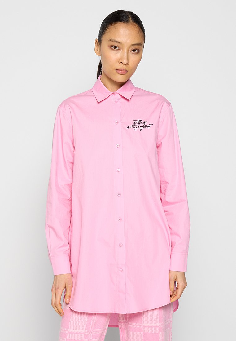Chemise à manches longues, rose clair, à boutons, avec un col et un détail de logo sur la poitrine gauche. Tissu lisse, coupe classique et ourlet droit.