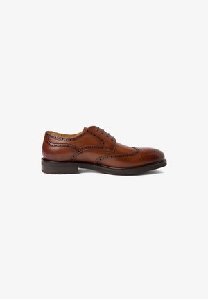 Brauner Leder-Wingtip-Brogue-Herrenschuh mit perforierten Details und dunkler Sohle, seitliche Ansicht auf weißem Hintergrund.