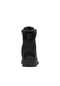 Black ankle boots with a smooth leather and suede exterior, fur-lined collar, and rubber sole. Features a side zipper for easy wear.