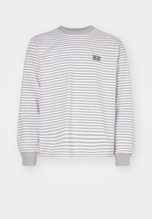 Striped long-sleeve shirt in gray and white. Features a round neck and gray cuffs. Small logo patch on the left side of the chest.