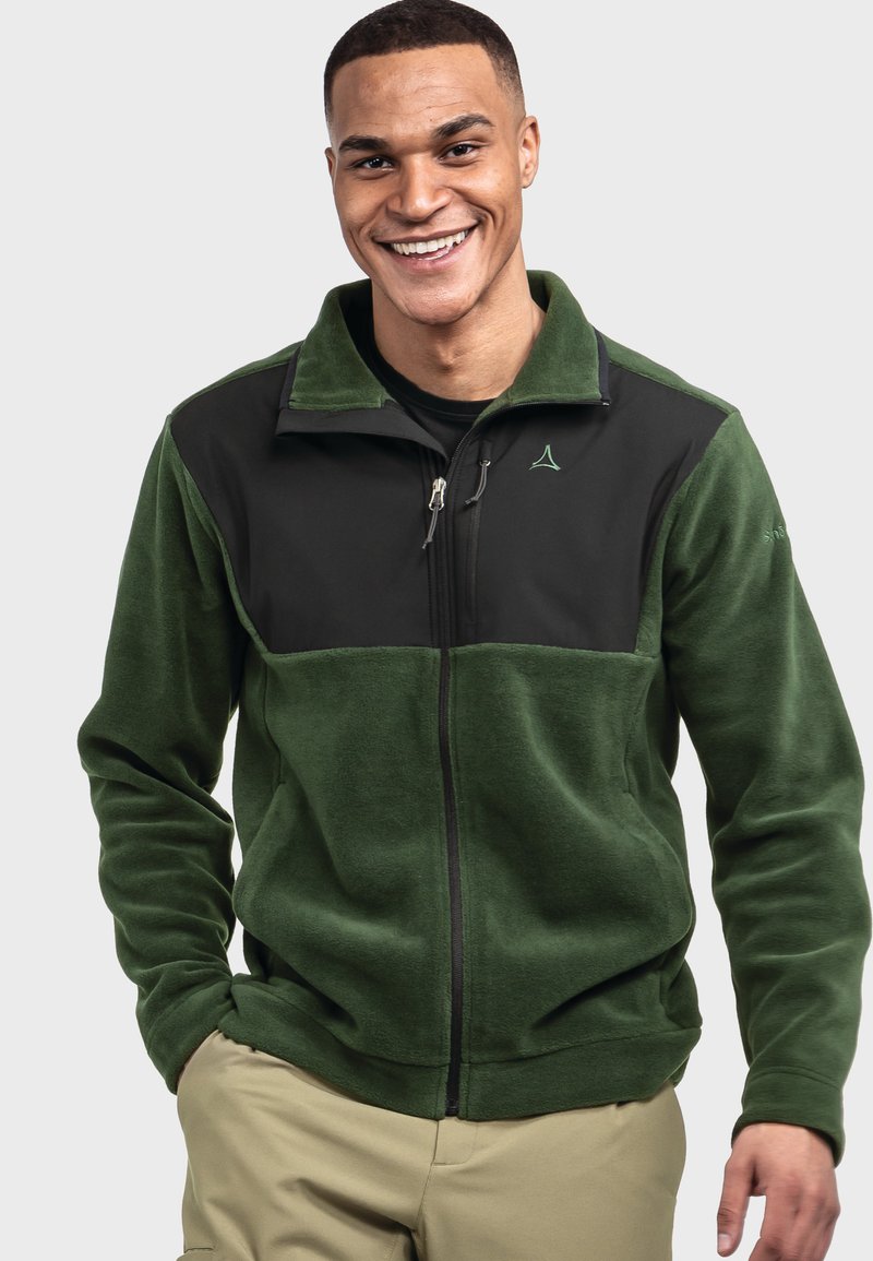 Grüne Fleecejacke mit schwarzem Oberteil, Reißverschluss, Stehkragen und grünem Logodetail. Glatte Textur, lockere Passform, funktionales Design.