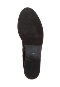 Suela de zapato negra con textura suave. Presenta una forma ovalada y una talla marcada "37" cerca del talón. Diseño minimalista sin elementos decorativos.