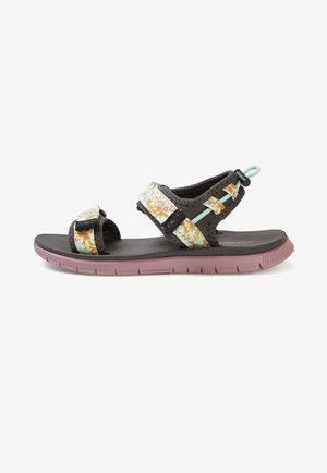 Sandale sportive à bout ouvert avec semelle noire, brides réglables à motif floral, et une semelle extérieure rose flexible à crampons.