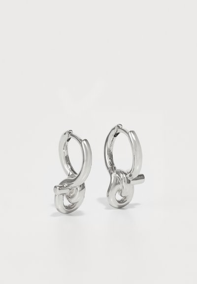 Silver hoop earrings with a twisted design, featuring a smooth, polished surface and interlocking links for added detail.