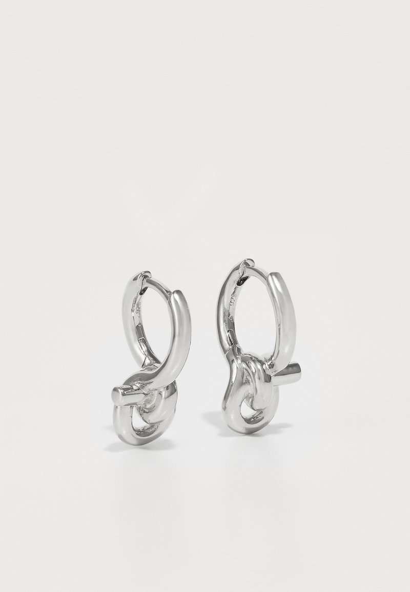 Silver hoop earrings with a twisted design, featuring a smooth, polished surface and interlocking links for added detail.
