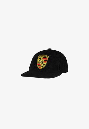Black corduroy baseball cap with a structured crown and a flat visor. Features an embroidered Porsche shield in red, yellow, and black.