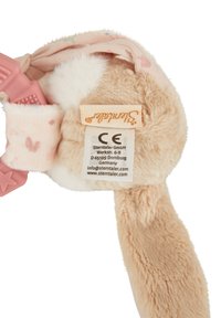 Plush bunny ear headband in light pink with heart patterns, soft furry texture, and adjustable pink hardware with a label tag.