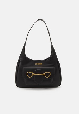 Black Love Moschino shoulder bag with a front flap pocket featuring gold heart-shaped metal clasps and a single strap handle.