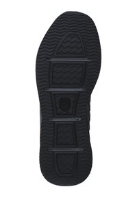 Black rubber shoe sole with zigzag tread pattern, featuring horizontal grooves and a shield logo at the center. Flat design, sturdy texture.
