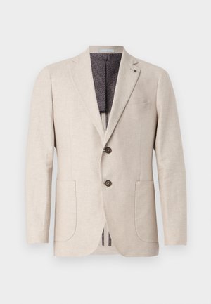 Blazer en lin beige avec deux poches avant, deux boutons, revers crantés et une doublure à motif gris foncé. Design épuré et tissu texturé.
