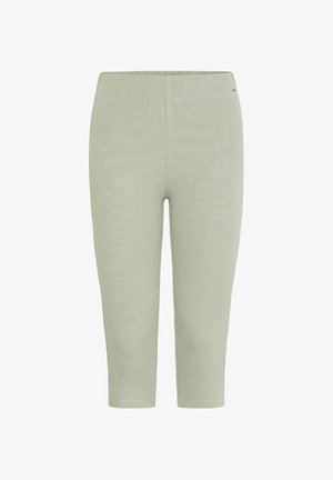 Heledad rohelised, lühikesed legginsid, mis on valmistatud ribakudumist. Tal on elastne vöökoht ja sile tekstuur, ilma nähtavate mustriteta.