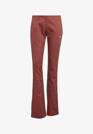 Tehlovej farby, vysoký pás, zvonové teplákové nohavice s malým strieborným logom Adidas na pravej stehnovej časti.