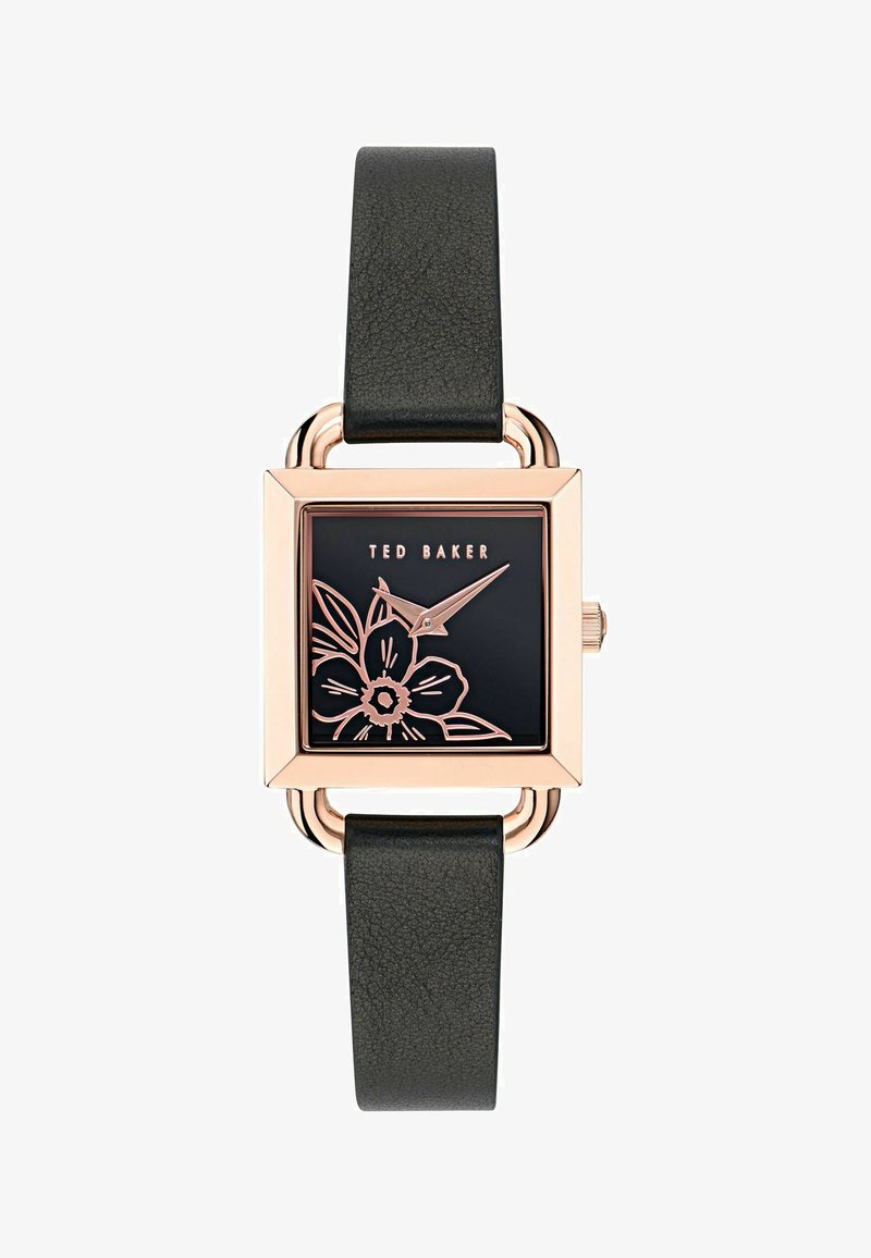 Ruutuline kell roosa kuldse korpusega, must lillemuster mustal taustal ja tekstureeritud must nahkrihm.