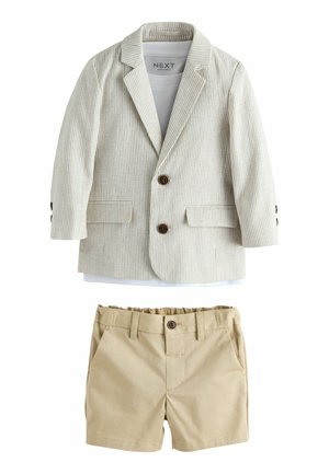 Striped beige blazer with two buttons and side pockets, paired with khaki shorts featuring an elastic waistband and a front button.