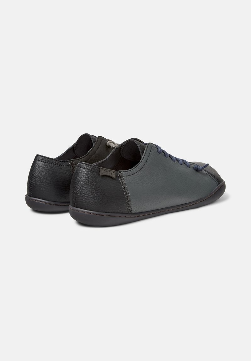 Two-tone shoes in gray and black leather, featuring a smooth texture, round toe, and contrasting laces with a logo on the heel.