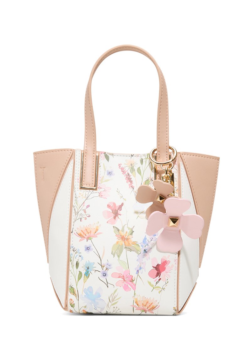 Kwiatowa torba na ramię w białym i beżowym kolorze, z zawieszką w kształcie kwiatu. Gładki materiał zewnętrzny, usztywniony kształt oraz podwójny uchwyt.