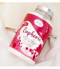 Glass jar of Babefee Euphoria milk bath with wild strawberry and rhubarb, resting on beige and white towels.