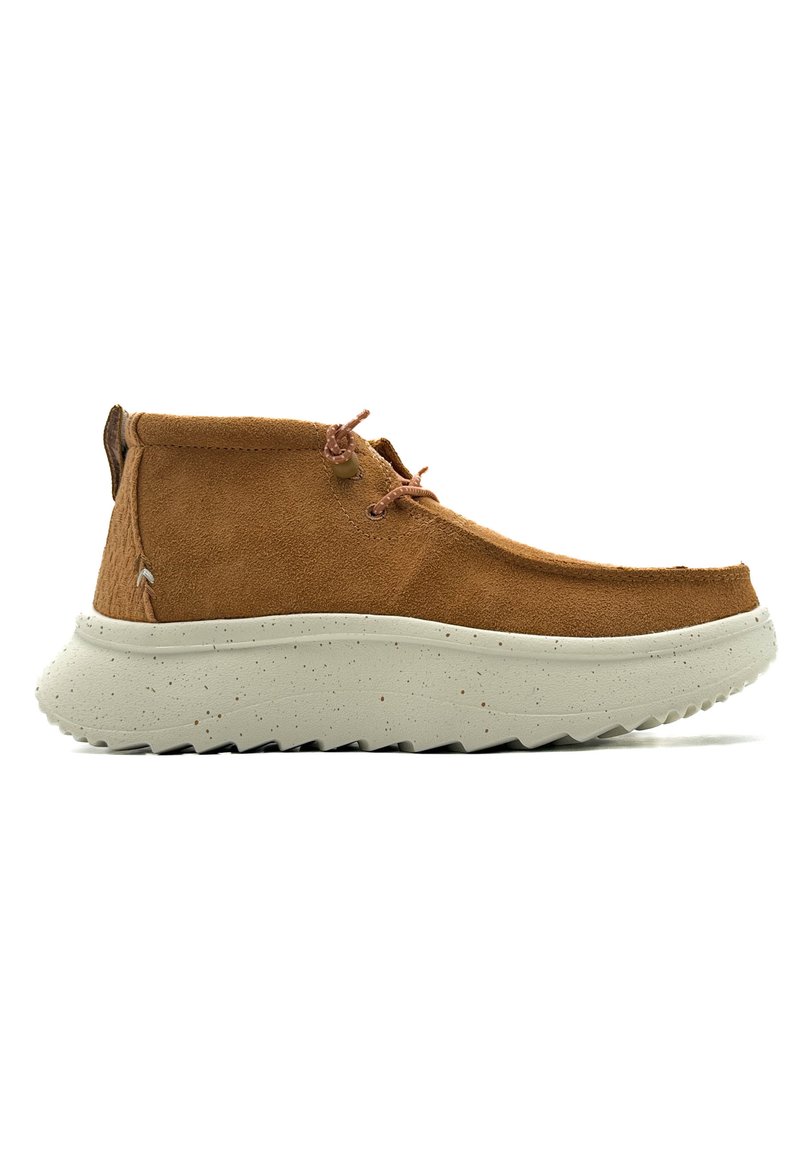 Brown suede ankle boots with a chunky off-white speckled sole, featuring a rounded toe and two brown laces for closure.