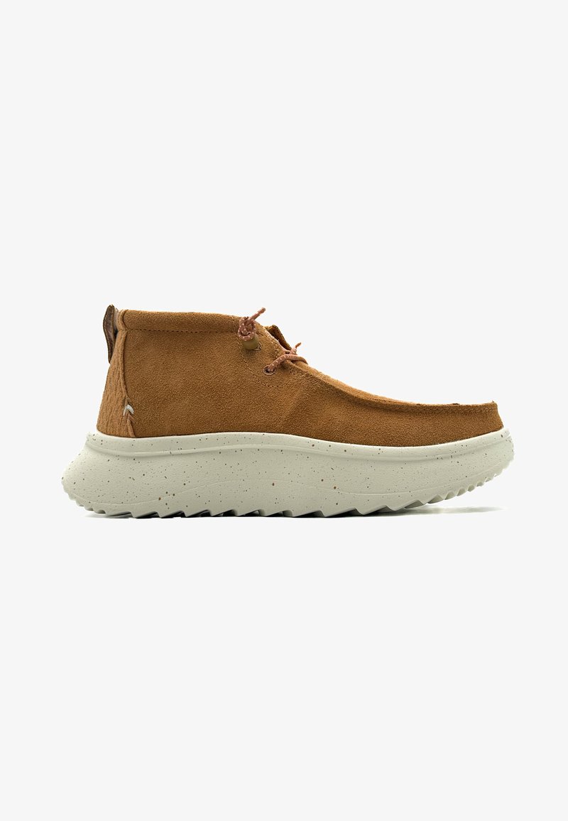 Brown suede ankle boots with a chunky off-white speckled sole, featuring a rounded toe and two brown laces for closure.