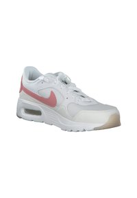 Las sneakers de Nike cuentan con un upper sintético blanco con acentos rosas, puntera redondeada, detalles texturizados y una unidad de amortiguación de aire visible en la suela.