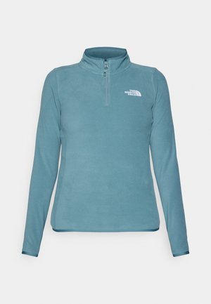 Fleece-Pullover in Teal mit hohem Kragen und Viertel-Reißverschluss. Auf der linken Brust befindet sich ein weißes Logo. Glatte Textur, lange Ärmel.