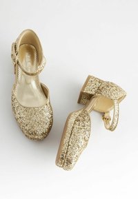 Goldene Glitzer-Mary-Jane-Schuhe mit runder Zehenpartie, Knöchelriemen und mittelhohem Blockabsatz. Strukturiertes Obermaterial mit glänzenden, metallischen Details.
