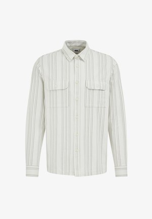 Hosszú ujjú világos bézs ing vékony fekete függőleges csíkokkal. Két mellzsebbel és gombos elülső részével rendelkezik, hegyes gallérral.