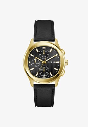 Herreklokke i gulltoner fra Guess med svart urskive, svart lærrem, tre underskiver for dag, 24-timers klokke og sekunder, og selvlysende visere.