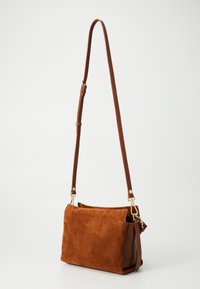 Brown suede shoulder bag with a structured shape, adjustable strap, and gold-tone hardware accents. Smooth leather sides and top opening.