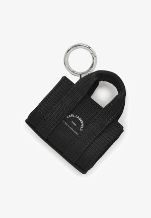 Small black fabric bag keychain featuring dual handles, a silver metal ring, and a logo printed on one side. Textured material.