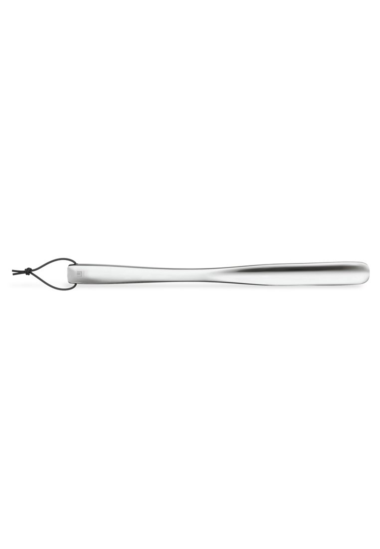 Stainless steel shoehorn with a sleek, elongated design; features a smooth surface and a black string loop for hanging.