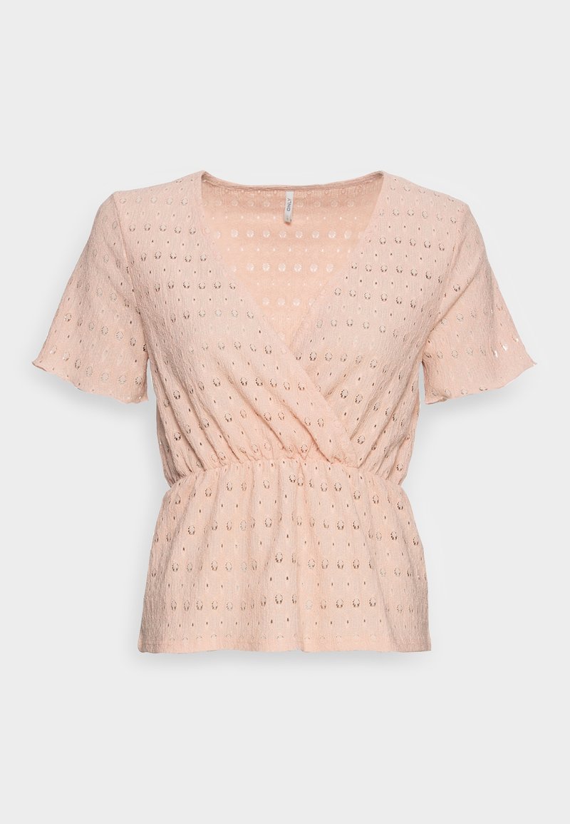 Blouse rose clair à manches courtes en tissu ajouré, devant cache-cœur en V et taille élastiquée froncée sur fond uni.