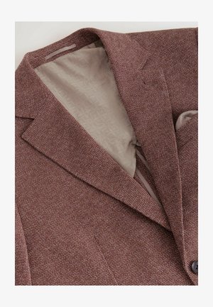 Bruine gestructureerde blazer met een notch-lapel en twee knopen. De binnenkant heeft een lichtgekleurde, gestippelde voering.