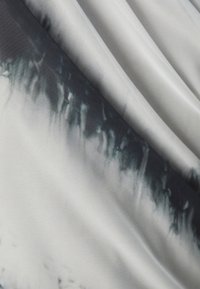 Soft fabric with a gradient from dark gray to white, featuring a slightly textured finish and fluid drape, creating a wave-like effect.