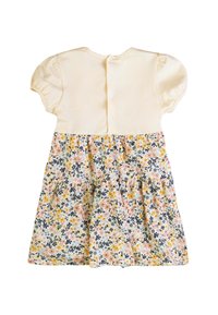 Abito giallo chiaro con maniche a sbuffo, caratterizzato da una stampa floreale in colori pastello. Chiusura a bottoni sul retro, strati testurizzati nella gonna.