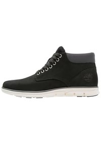 Svarta läderankelstövlar med grå textilkrage, vit gummisula, rund tå och metallöglor för snörning. Timberland-logotyp på baksidan.