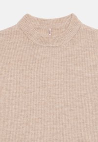 Beige ribbed knit sweater with a round neck collar and a small clothing tag inside the neckline.