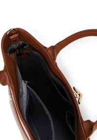 Brown leather handbag with a zippered closure, featuring an interior zip pocket and lined with dark fabric displaying a wavy pattern.