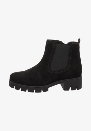 Stivaletto in suede nero con pannelli laterali elasticizzati, suola in gomma chunky e anello posteriore per una facile calzata. Presenta una texture liscia e cuciture minime.