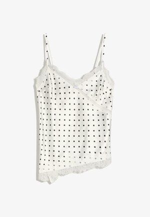 Witte satijnen cami met zwarte stippen, kanten rand langs de halslijn en zoom, en dunne verstelbare schouderbandjes.