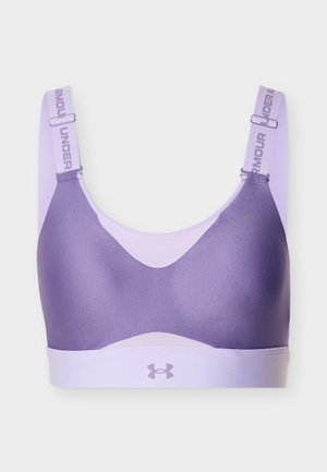 Paarse en lavendelkleurige sportbeha met verstelbare bandjes en het Under Armour-logo op de band, ontworpen voor sportieve ondersteuning en comfort.