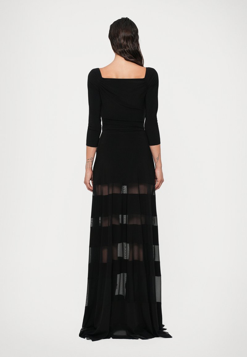 Black dress with long, sheer skirt featuring horizontal stripes, fitted bodice, square neckline, and three-quarter sleeves. Soft, flowing material.