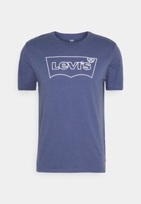 Námořnická modrá bavlněná trička s bílým logem Levi's v klasickém designu. Krátké rukávy a kulatý výstřih. Hladká textura.