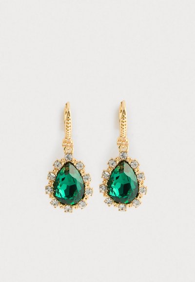 Gold earrings with large teardrop green gemstones surrounded by small clear crystals on a white background.