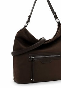 Brown fabric shoulder bag with a slouchy design, featuring a zippered front pocket and a leather strap. Soft texture and subtle accents.
