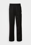 STRIPE - Tracksuit bottoms - black